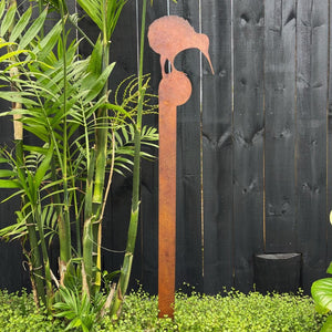 Kiwi steel garden sculpture stake standing in a landscaped New Zealand backyard.
