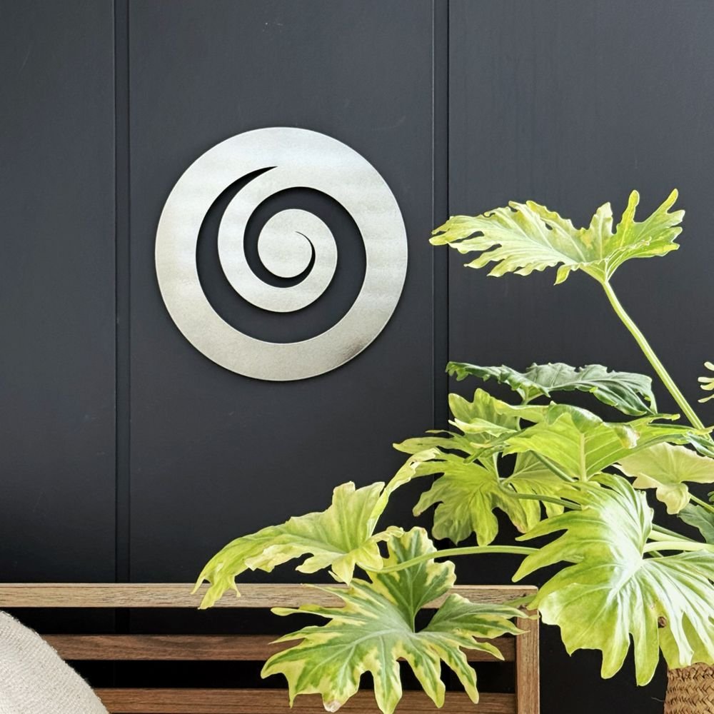 Modern metal koru wall art by LisaSarah, brightening a stylish New Zealand backyard space. 