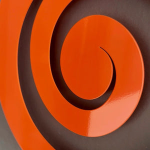 LisaSarah's vibrant orange koru wall art adding Kiwi culture to a modern New Zealand living room