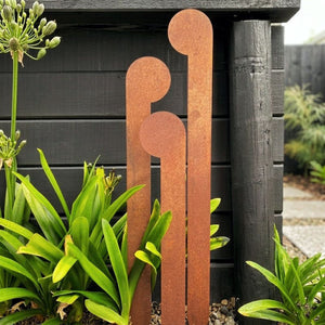 Front view of 3 corten steel koru garden stakes NZ – varying heights – LisaSarah Steel Designs