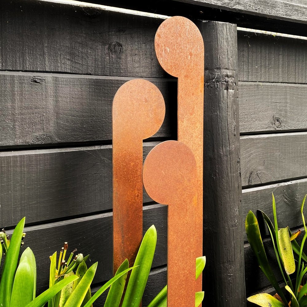 Set of 3 steel koru garden stakes in NZ garden – outdoor sculpture and ornament