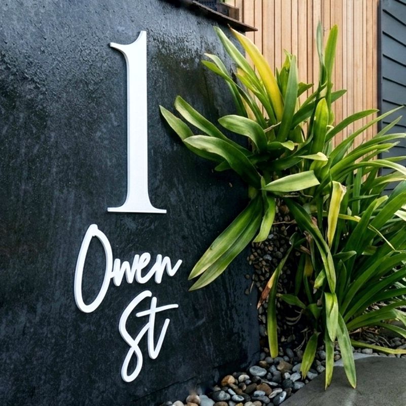 Modern house number on contemporary home exterior in New Zealand