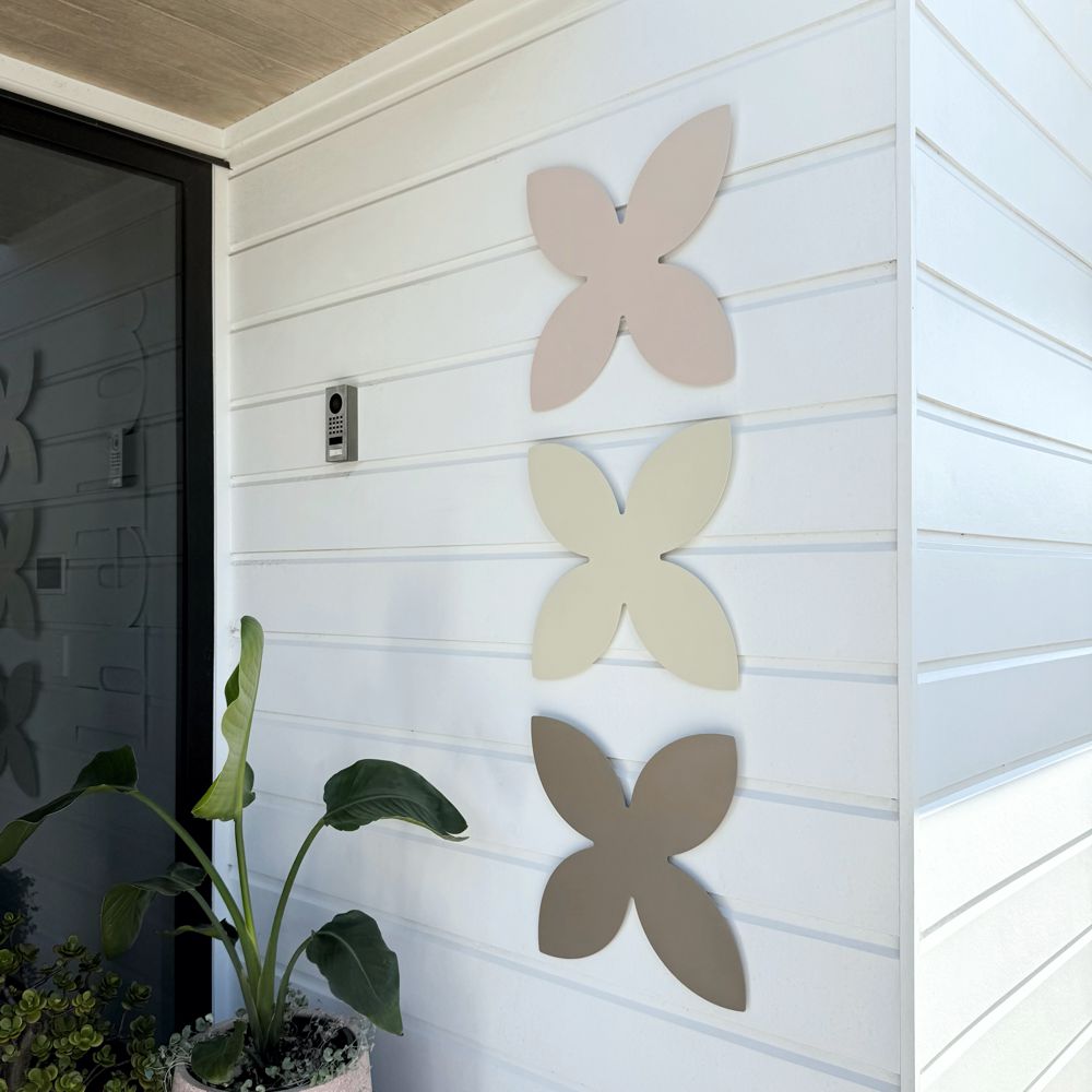 Urban chic blush, magnolia and pale bronze frangipani wall art in entryway in modern New Zealand home. 