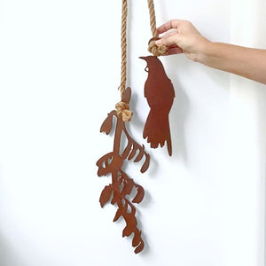 Close-up detail of New Zealand corten steel tūī bird with flax garden wall art — handcrafted outdoor wall hanging
