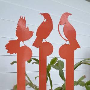 Close up of orange bird garden art in a planter by LisaSarah