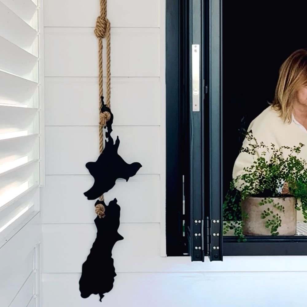 Stylised New Zealand map in laser-cut steel, outdoor wall art featuring native design elements