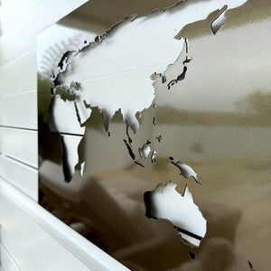 Close-up of laser cut steel continents in pewter bronze