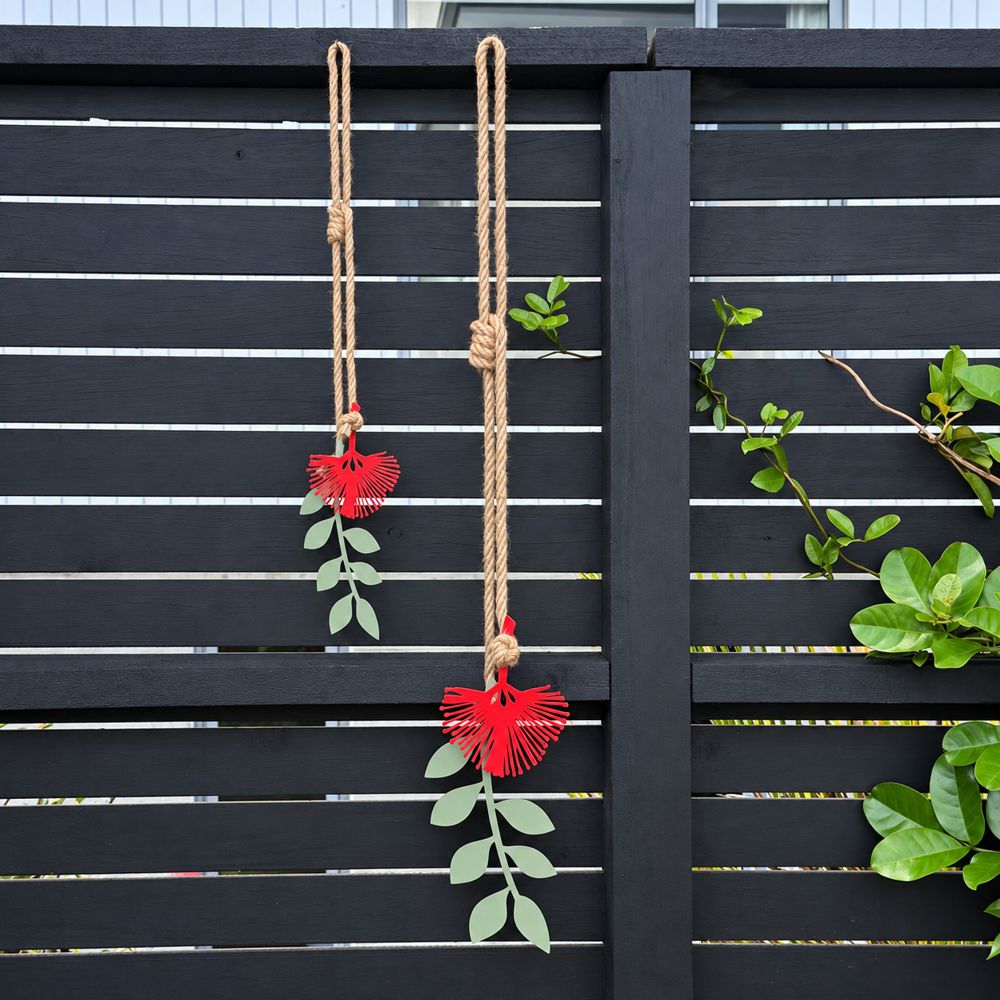 Pohutukawa red and green wall hangining on garden fence in Auckland