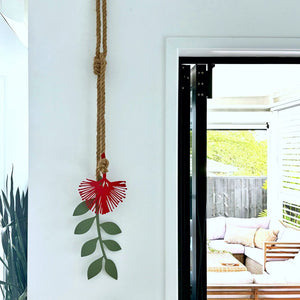 Contemporary NZ made Pohutukawa wall art with red blooms and green foliage styled in a modern New Zealand kitchen interior.
