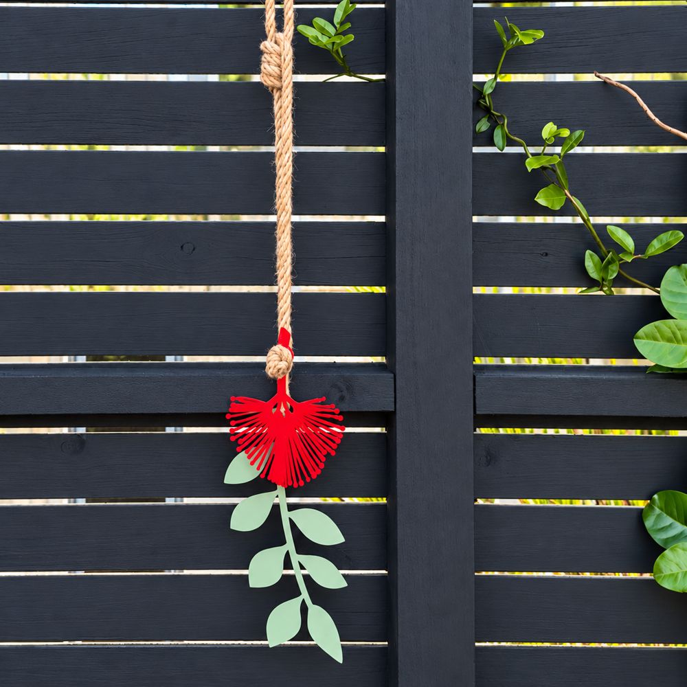 Pohutukawa red and green wall hangining on garden fence in Auckland