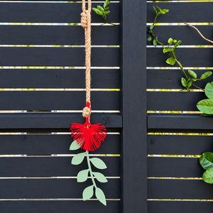 Pohutukawa red and green wall hangining on garden fence in Auckland