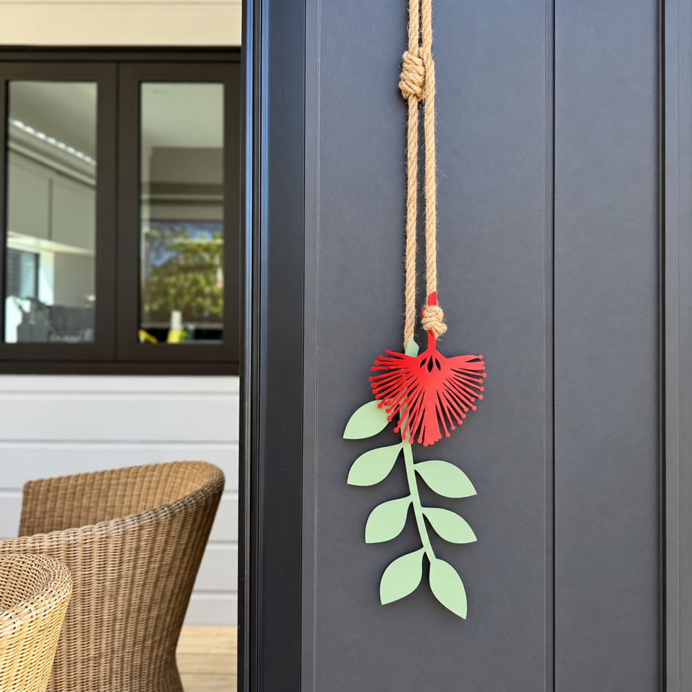 Pohutukawa wall hanging on black house in NZ patio