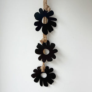 Close up of matt black steel floral wall hanging