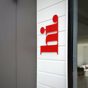 Red outdoor wall art, 'hi' on modern NZ home front door 