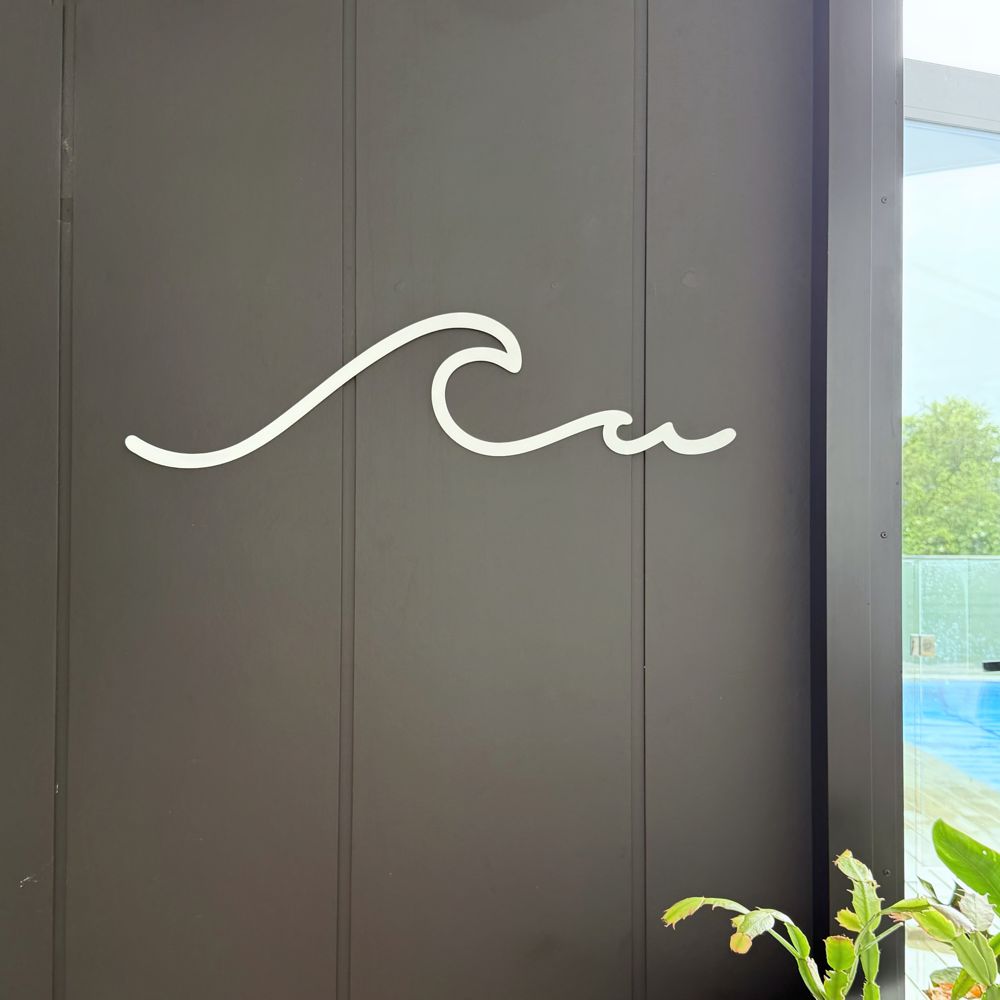 Coastal white wall art for indoors or outdoors - shown in modern NZ backyard on wall. 