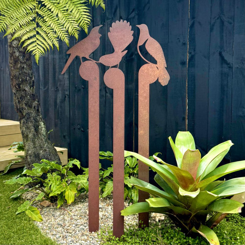 NZ-made corten steel garden art stakes featuring Fantail, Tui, and Kereru birds, perfect for outdoor gardens and patios.
