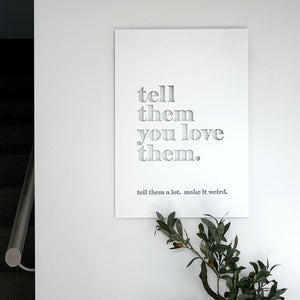 Tell them you love them, tell them alot  metal poster art in an entryway in modern home in New Zealand. 