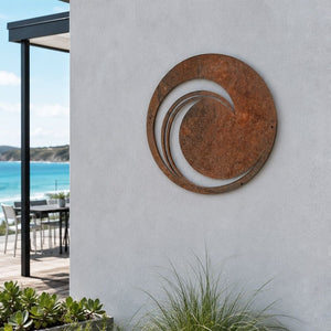 Round corten steel wave wall mounted on a coastal New Zealand home. 