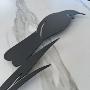 Close up of modern tui and flax silhouette wall art in matt black aluminium.