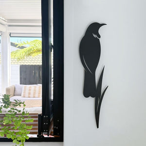 Contemporary tui and flax silhouette wall art in matt black aluminium styled in a New Zealand kitchen