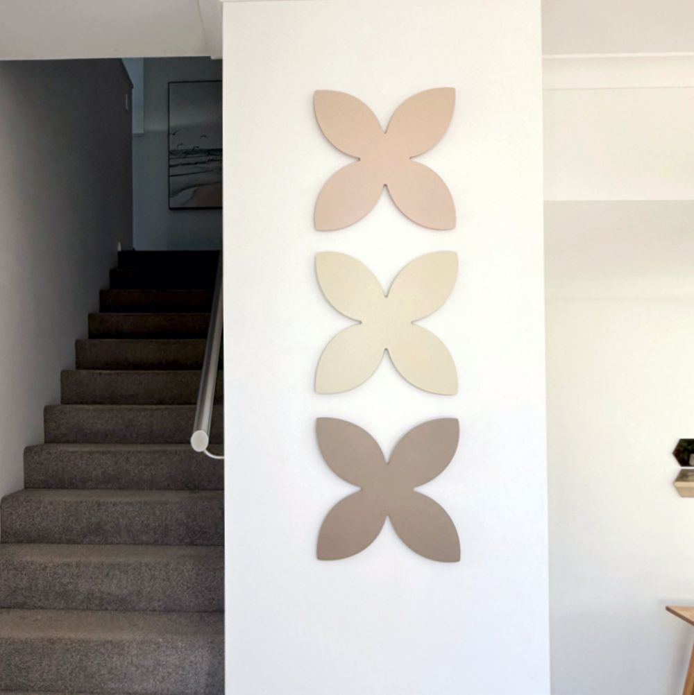 Urban chic blush, magnolia and pale bronze frangipani wall art in entryway in modern New Zealand home. 