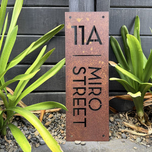 Corten steel house numbers on landscaped garden entrance NZ