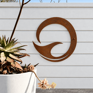 Large round corten steel whale tail art on white pool fence in Auckland, New Zealand. 