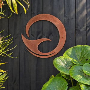 Large rusty corten steel whale tail art on fence in Auckland, New Zealand. 