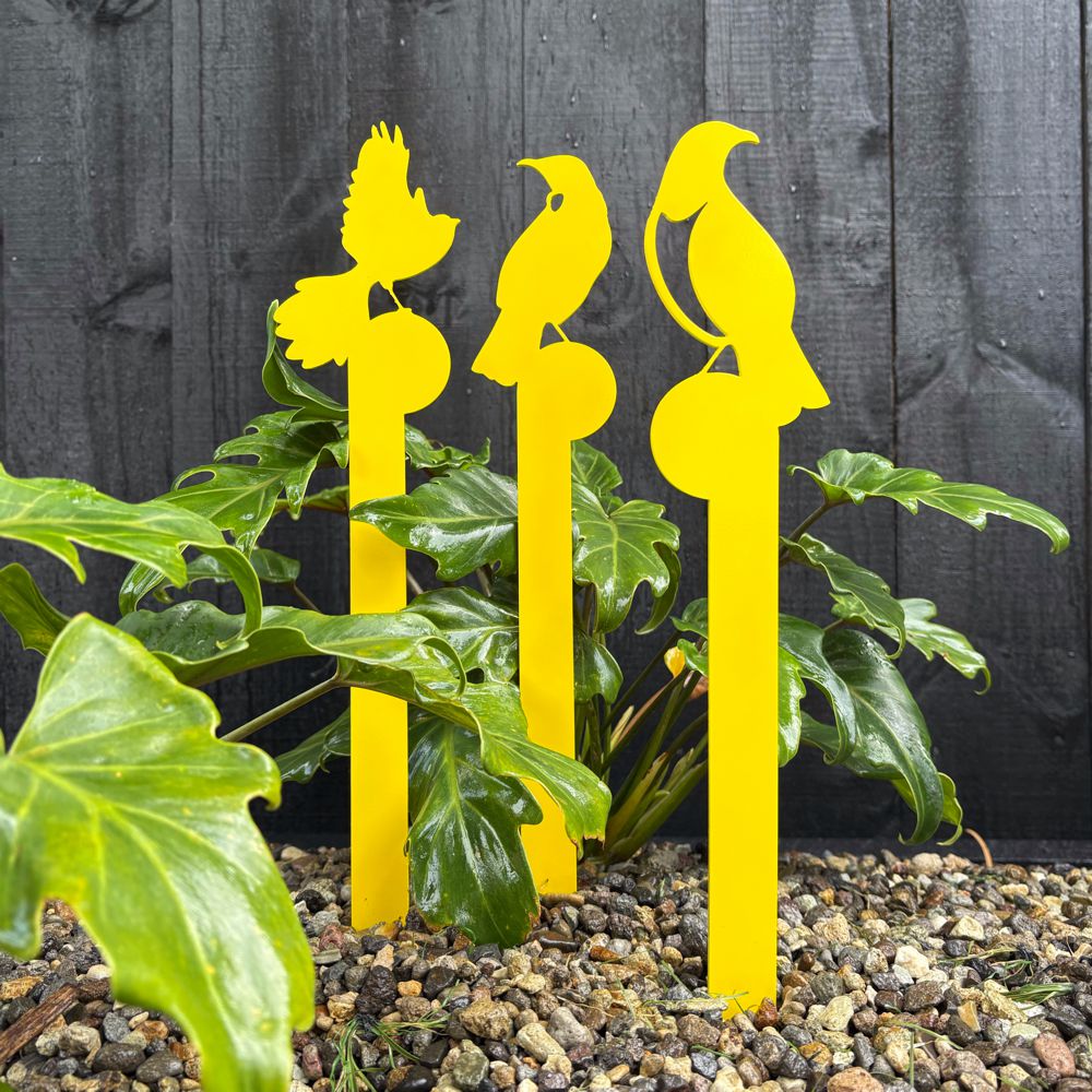 Yelllow aluminium NZ bird garden  planter stakes in garden in New Zealand. 