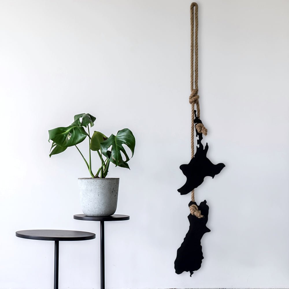 Stylised New Zealand map in laser-cut steel, outdoor wall art featuring native design elements