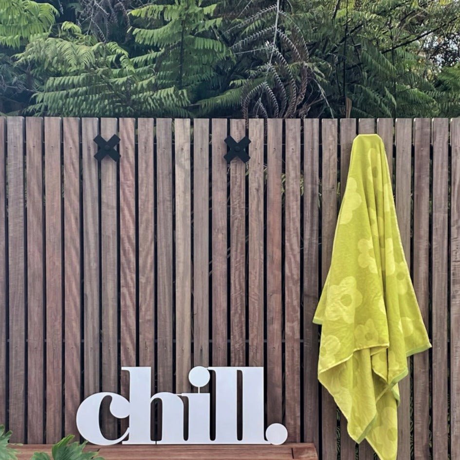 Black steel wall hooks on outdoor wall - NZ-made coat and towel hooks for indoors or out. 