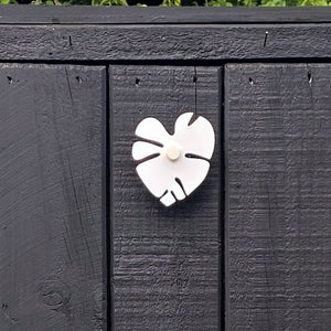 Middle monstera wall hook for exterior wall.  Great for pool towels. 