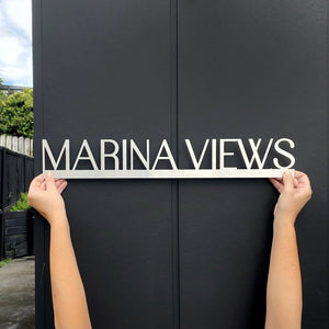 NZ made floating house name sign in marine grade brushed stainless steel by Lisa Turley. 