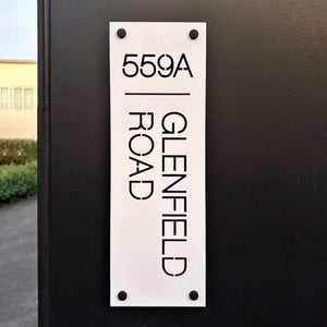 White steel with black standoff wall mount.  House number sign NZ.